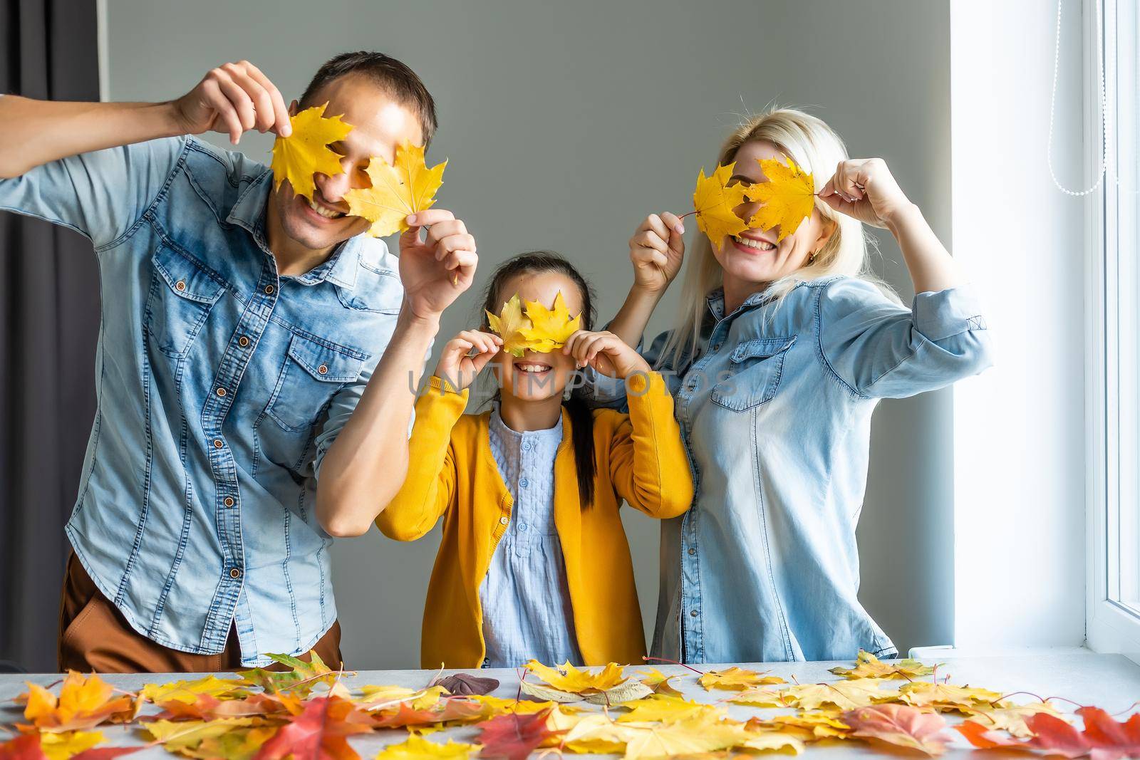 Happy family doing autumn decor. Fall atmosphere by Andelov13