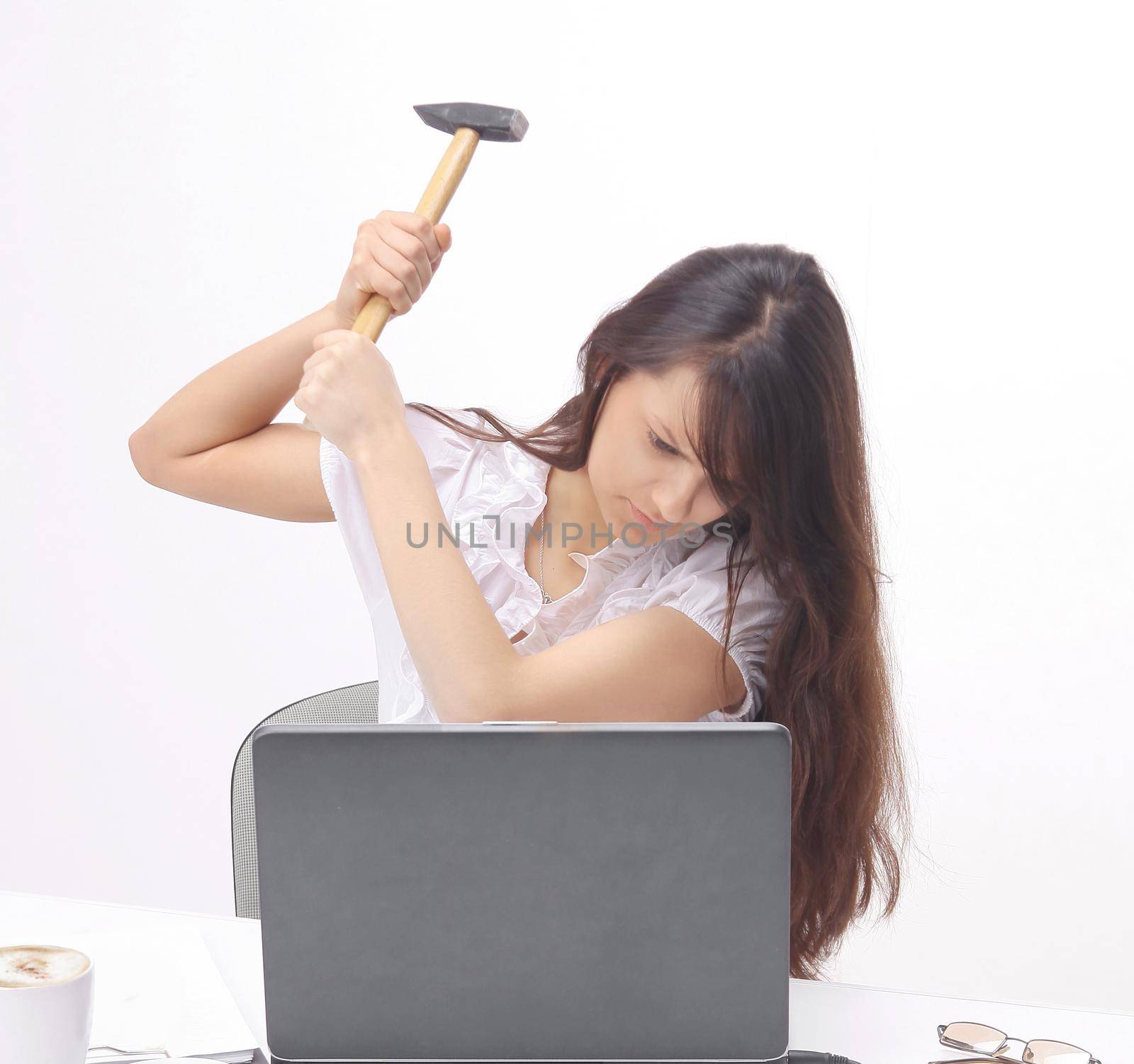 young business woman smashing a laptop sitting behind a Desk.photo with copy space