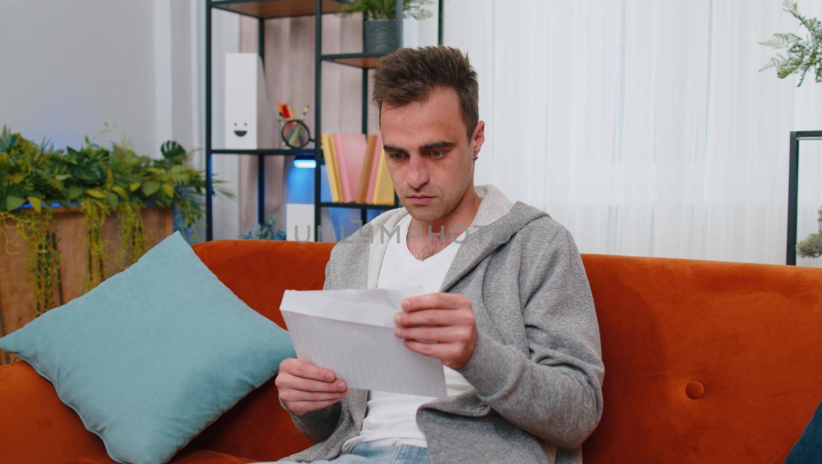 Happy man open envelope letter, reading it. Career growth advance promotion, bank loan approve, successful admission to university, monetary award, long-awaited invitation great news, lottery game win