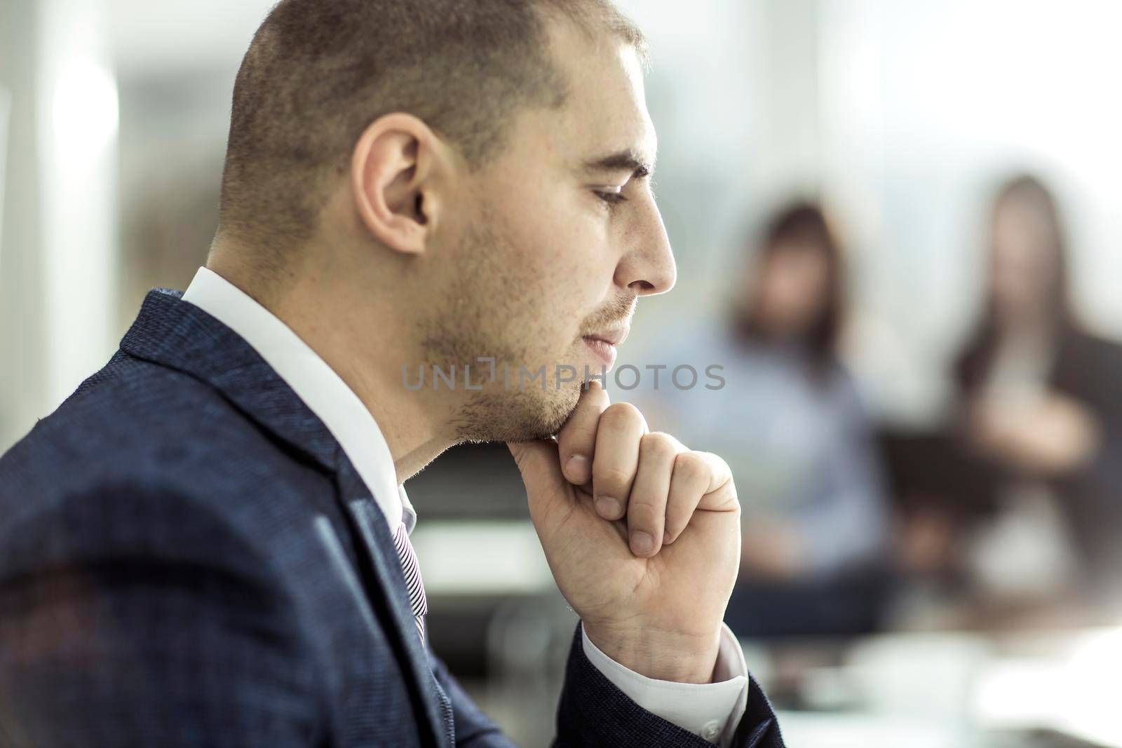 closeup of a senior Manager at the workplace on the background of business team