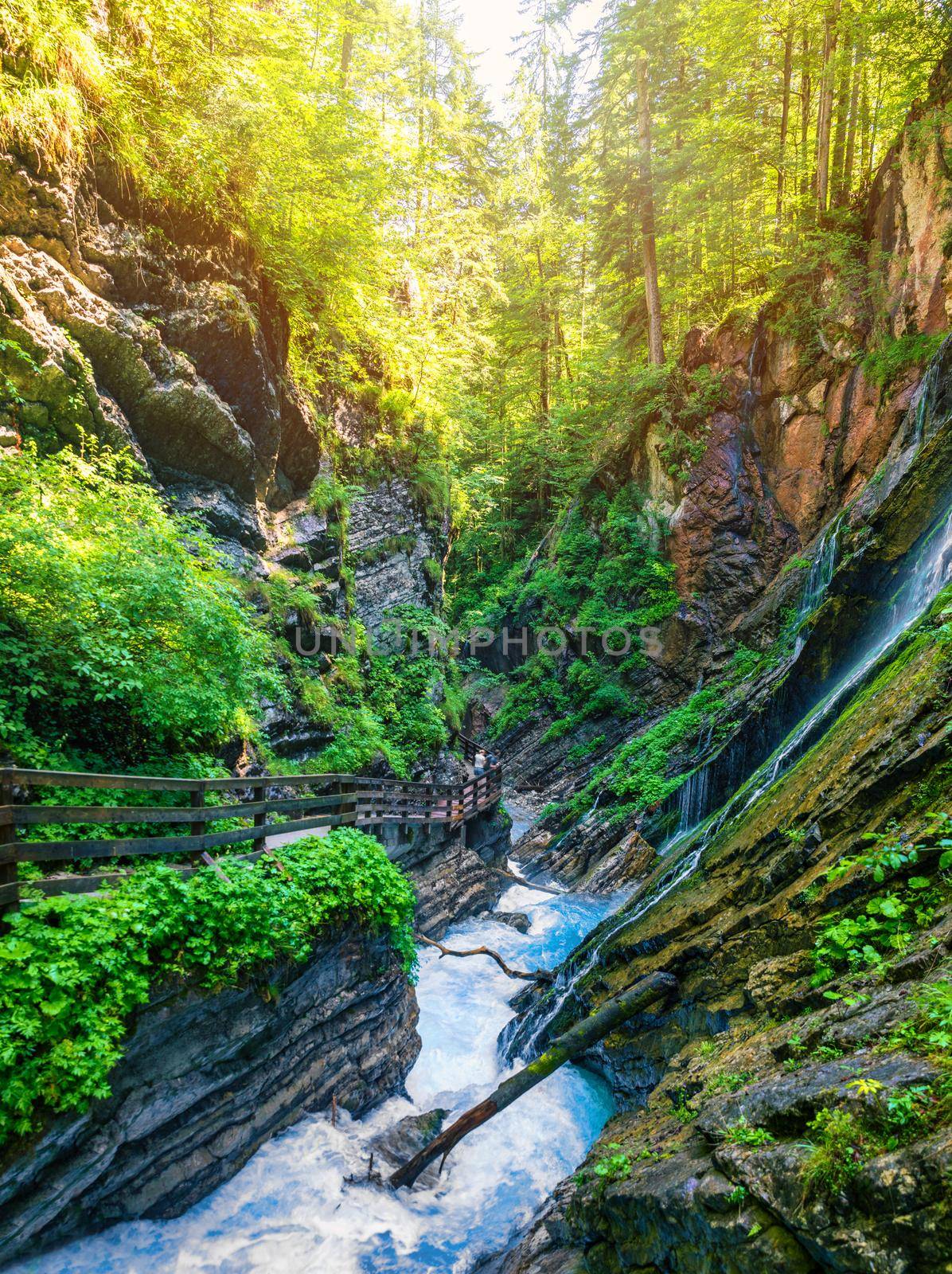 Beautiful Wimbachklamm gorge with wooden path in autumn colors, Ramsau bei Berchtesgaden in Germany. Waterfall at Wimbachklamm near Ramsau-Berchtesgaden, Bavaria, Germany.