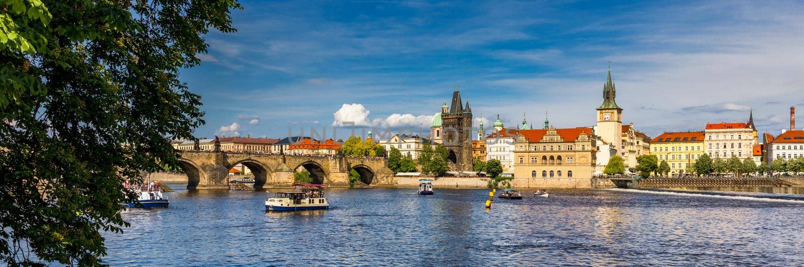 Prague in a sunny day, view of the old town, Prague, Czech Republic. Scenic summer view of the Old Town pier architecture and Charles Bridge over Vltava river in Prague, Czech Republic