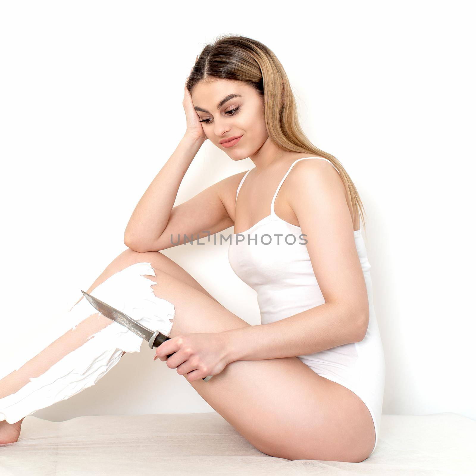 Woman shaves her legs with a knife by okskukuruza