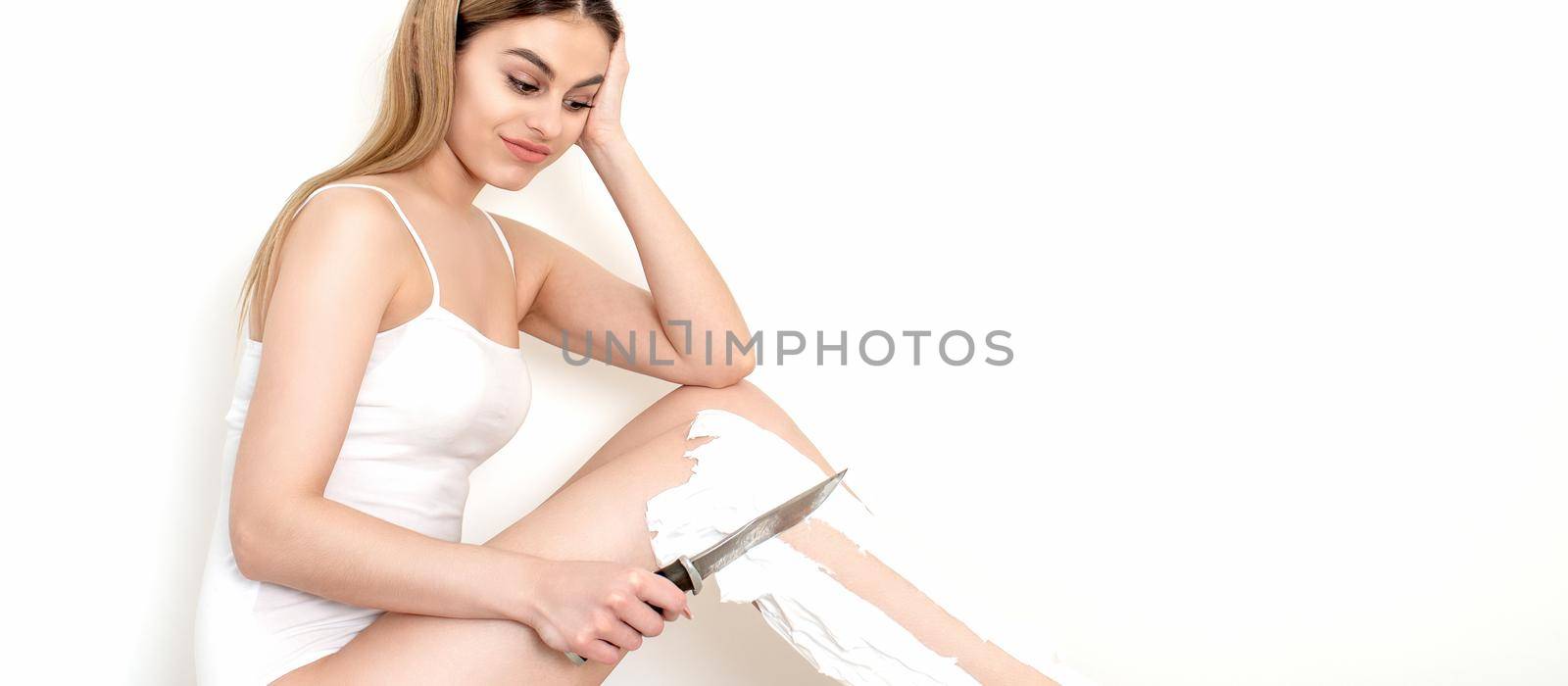 Woman shaves her legs with a knife by okskukuruza