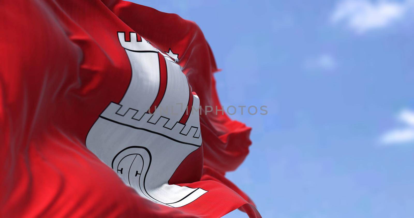 The flag of Hamburg waving in the wind on a clear day. Hamburg is the second-largest city in Germany