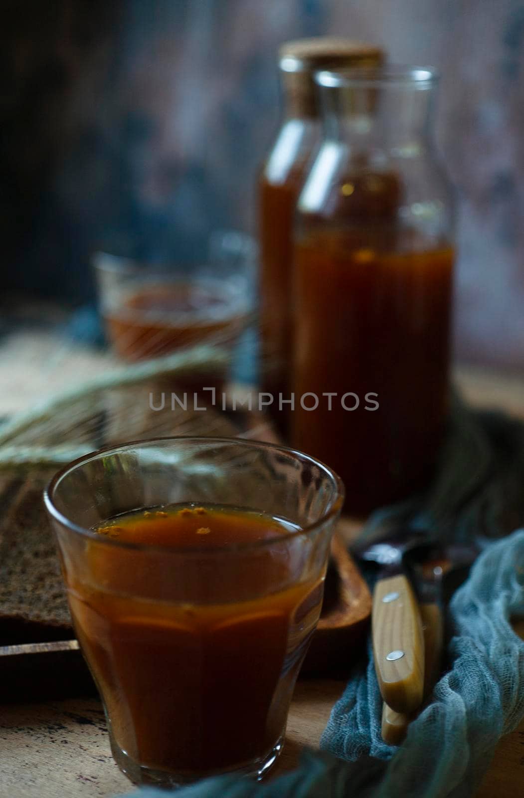 A glass of traditional homemade kvass on blue background, close up, selective focus.