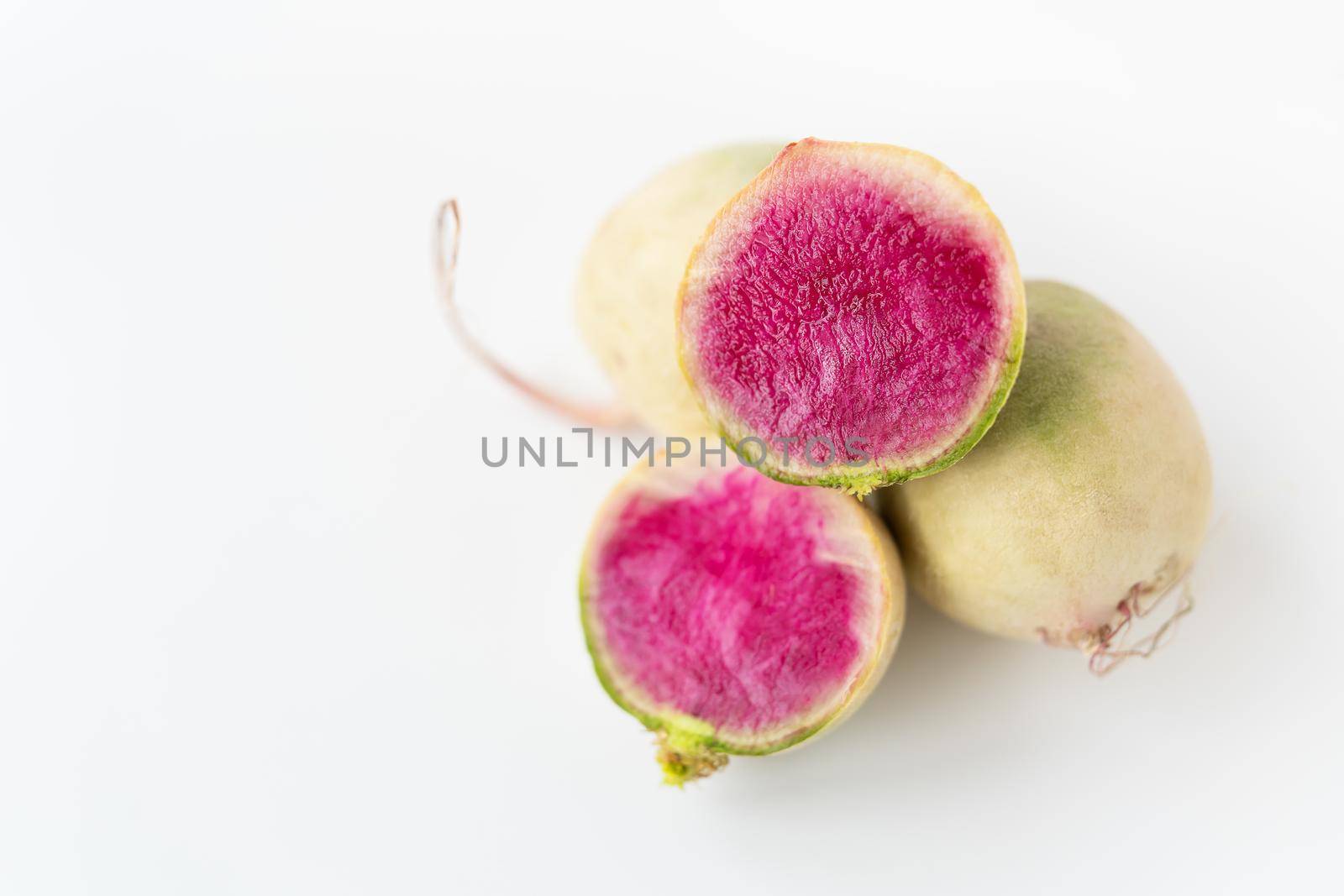 Delicious pink radish in the cut of the dragon's eye variety on a white background. View from above. by sfinks