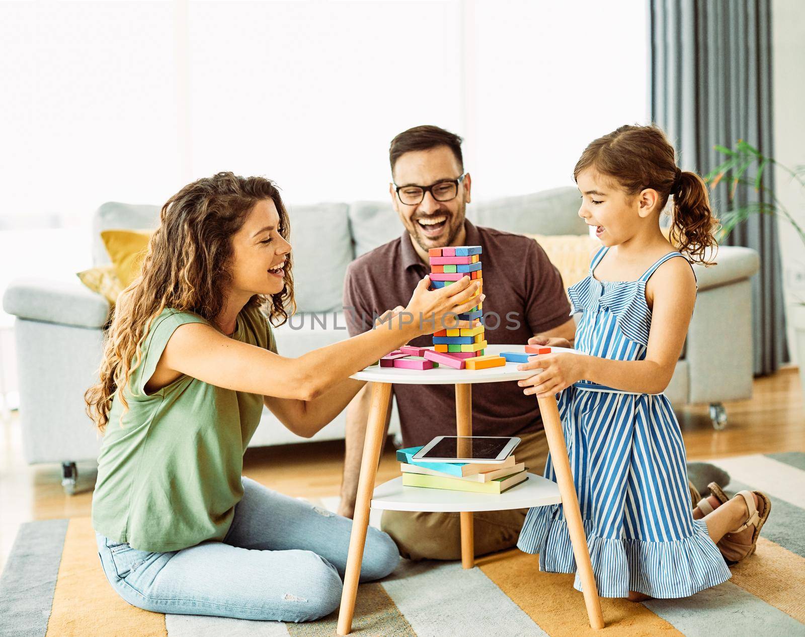 child daughter family happy mother father board game palying playing fun together girl cheerful home by Picsfive