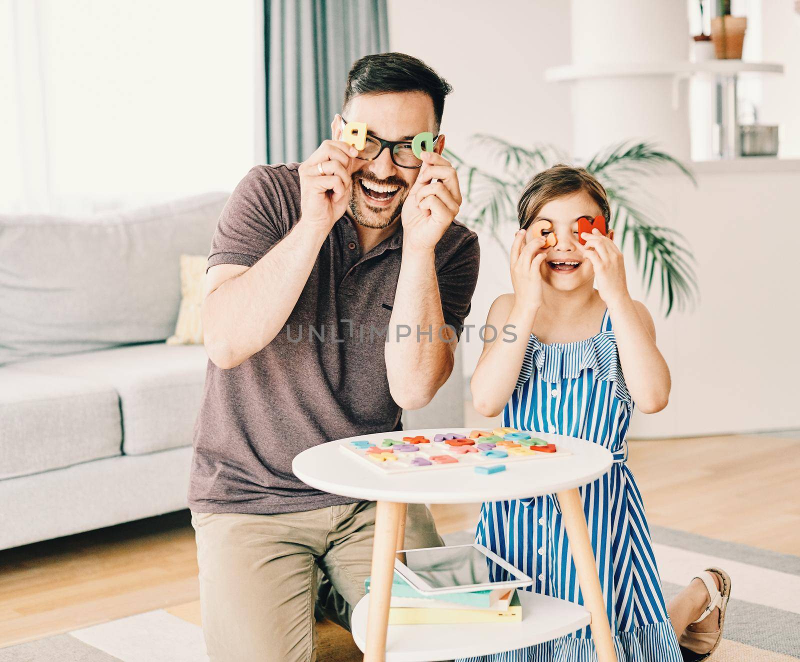 Family having fun playing board games in living room at home