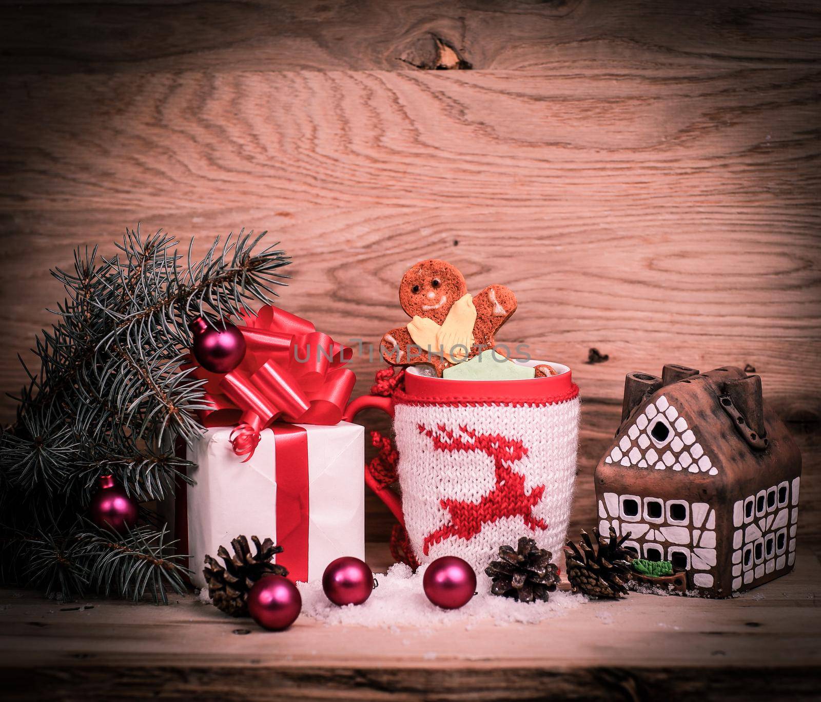 Christmas Cup,gingerbread house and a box of gifts .photo with space for text