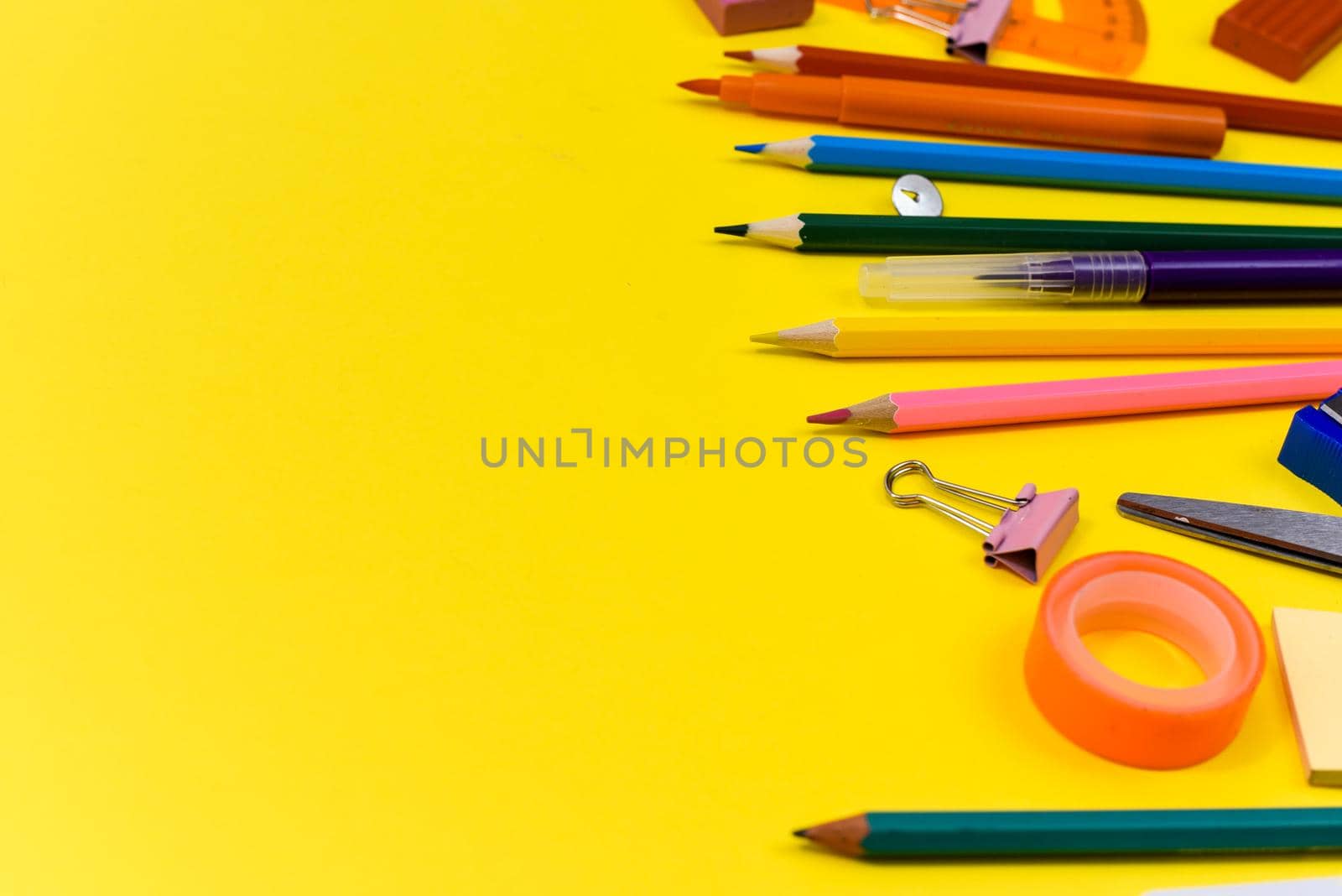 School accessories on a yellow background. Copy space. Back to school creative flat lay.