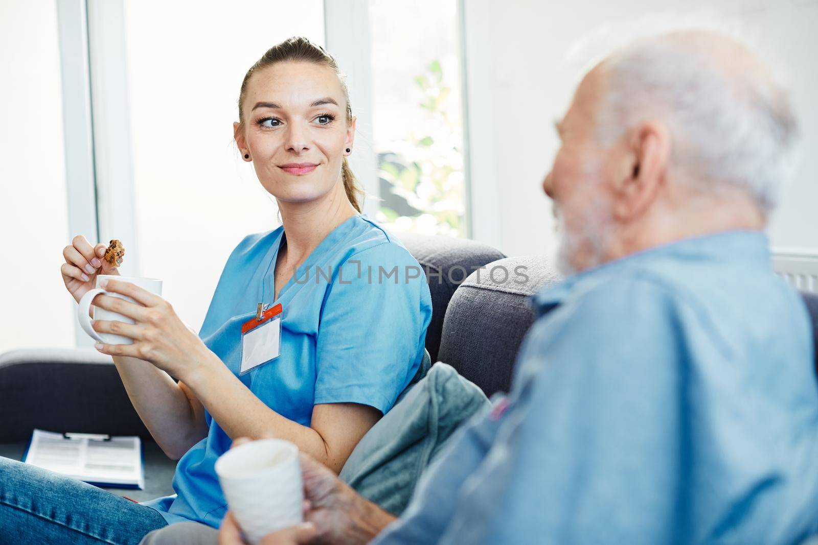 Doctor or nurse caregiver with senior man at home or nursing home