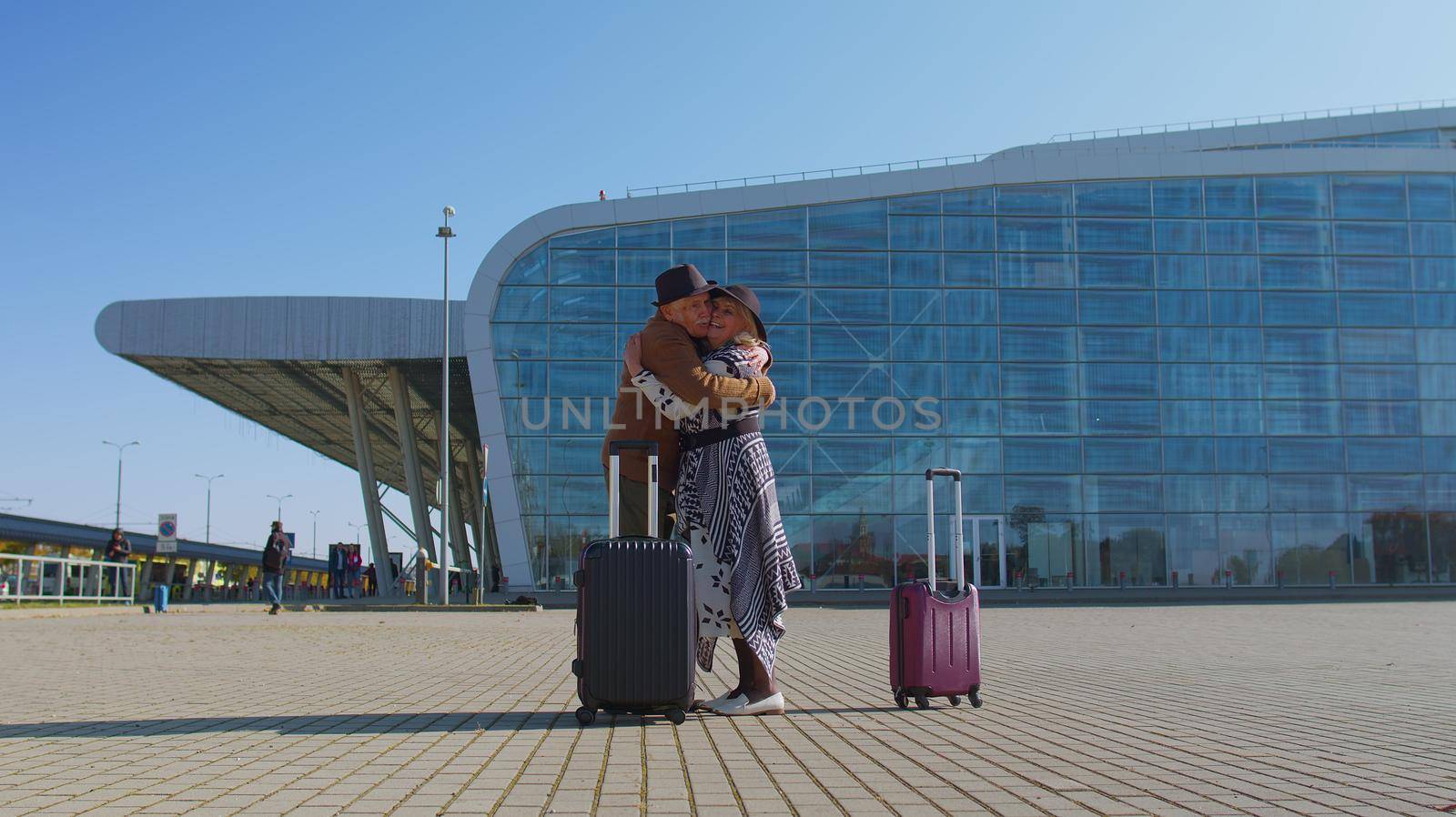 Elderly old husband wife retirees tourists reunion meeting in airport terminal after long separation by efuror