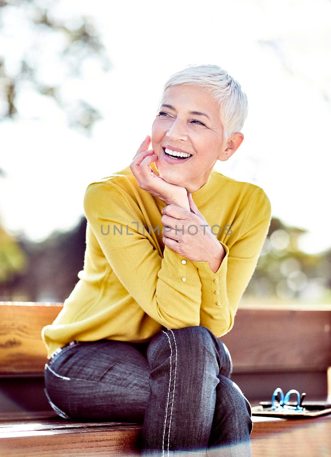 portrait of a happy smiling senior woman with grey hair outdoors