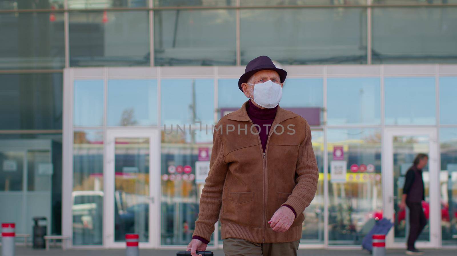 Senior old pensioner tourist male grandfather businessman wearing Protective Face Mask, avoid disease COVID-19 coronavirus infection near airport pandemic disease virus epidemic air health illness