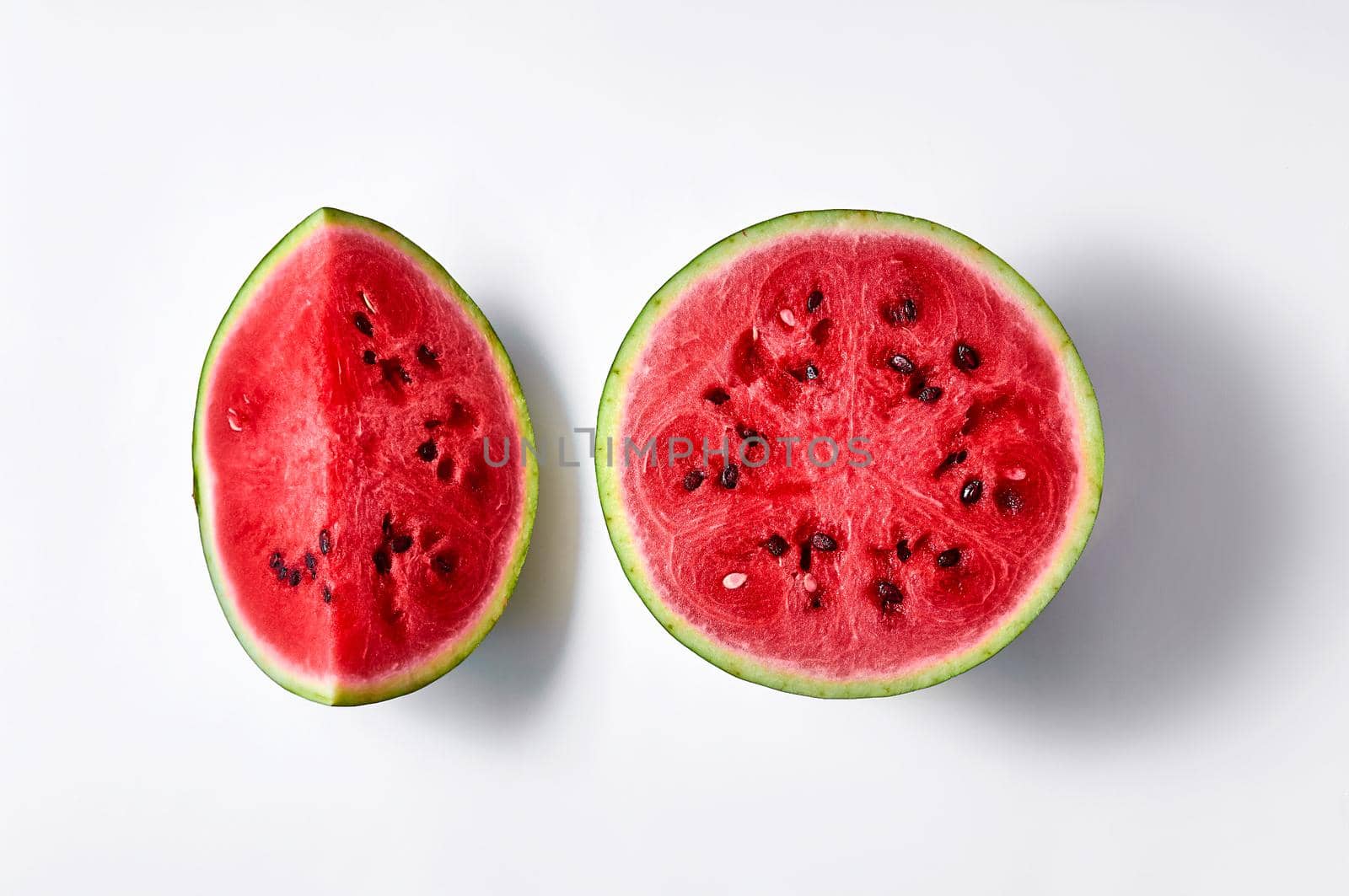 Fresh ripe cut watermelon isolated on white background. Creative minimal concept. Top view Flat lay.