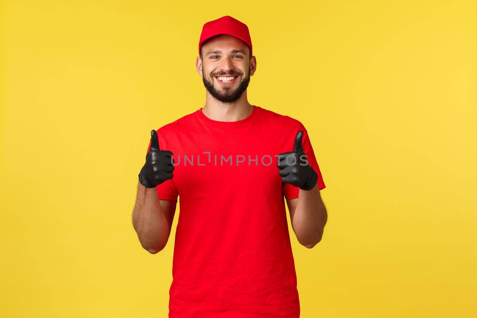 Express mail delivery, package transfer and logistics concept. Satisfied bearded handsome courier, deliver fast and safe parcel, show thumbs-up, wearing uniform and protective gloves.