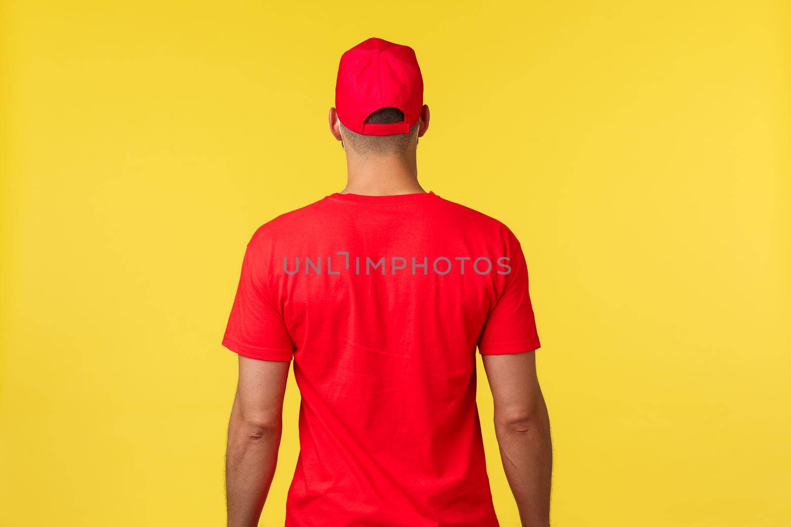 Express delivery during pandemic, covid-19, safe shipping, online shopping concept. Back of courier wearing red uniform t-shirt and cap, promo of logistic freight transportation company.