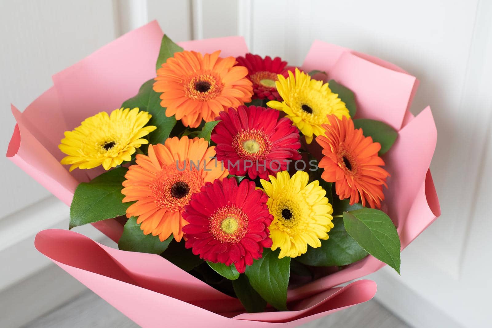 Bouquet of red, yellow and an orange gerberas by olgavolodina