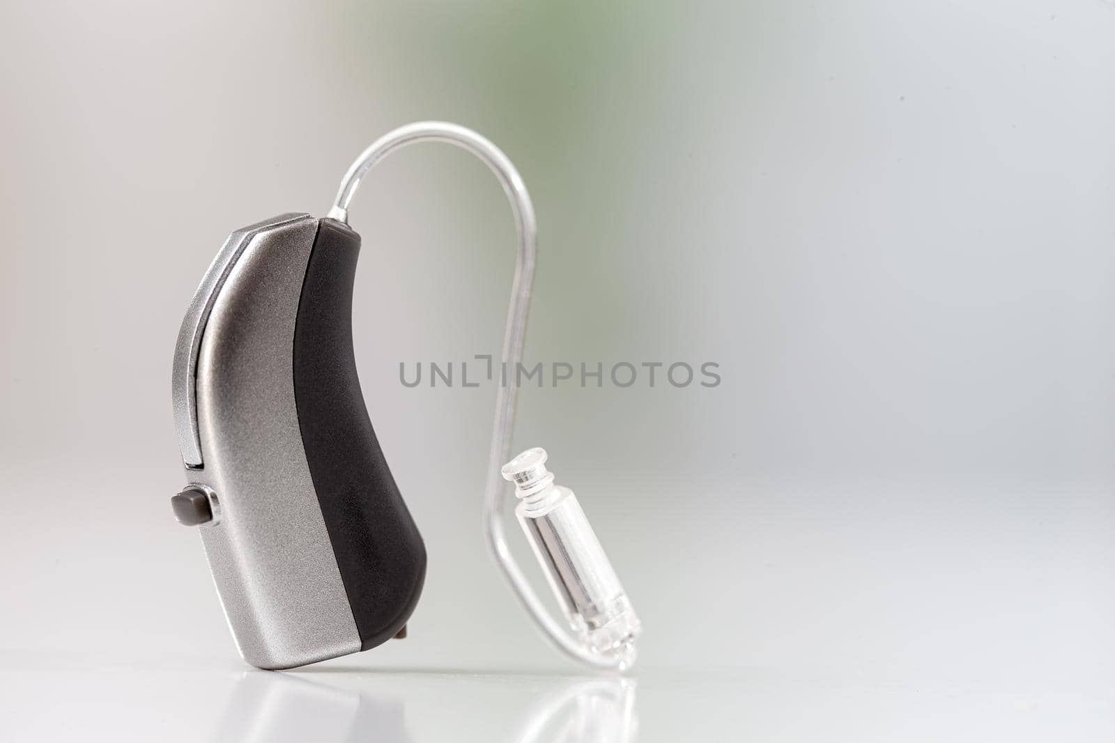 Hearing aid on a gray background by JPC-PROD