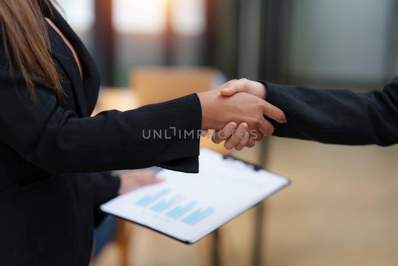 Business partnership meeting concept. Image business woman handshake. Successful business people handshaking after good deal. Group support concept. by itchaznong