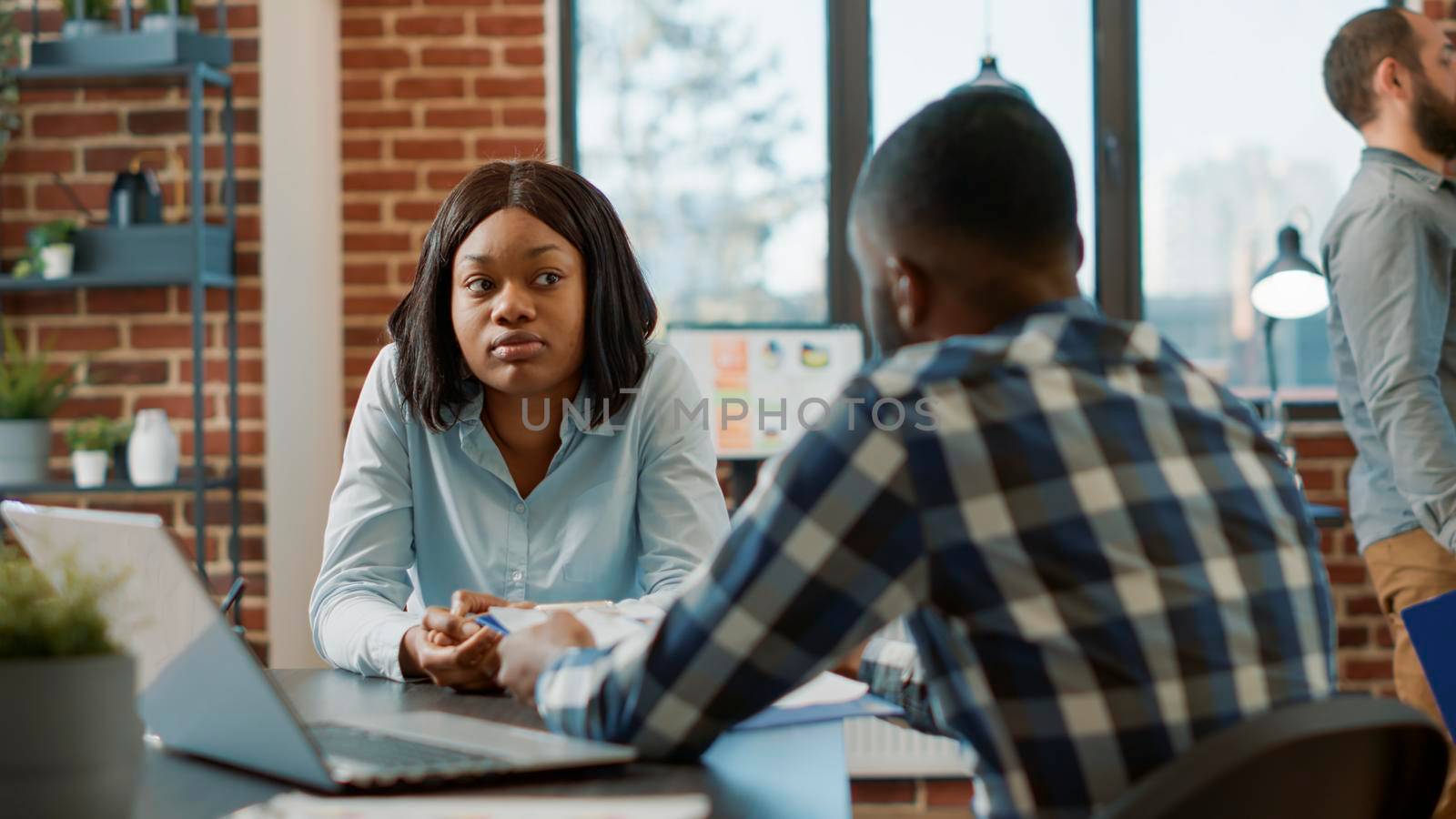 African american man and woman attendng job interview, having conversation about hiring selection and work application. Office worker interviewing female candidate about job offer.