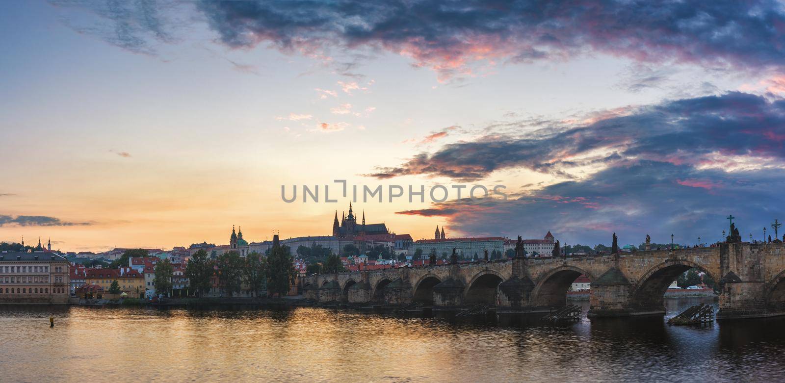 View of Prague Castle and Charles Bridge at sunset. Czechia