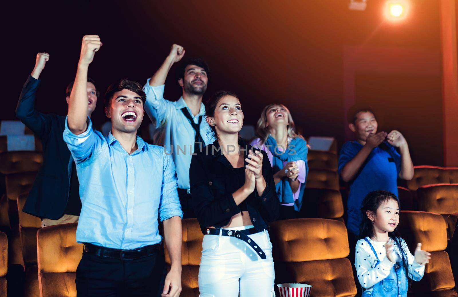 Group of audience happy and fun watch cinema in movie theater. Group recreation activity and entertainment concept.
