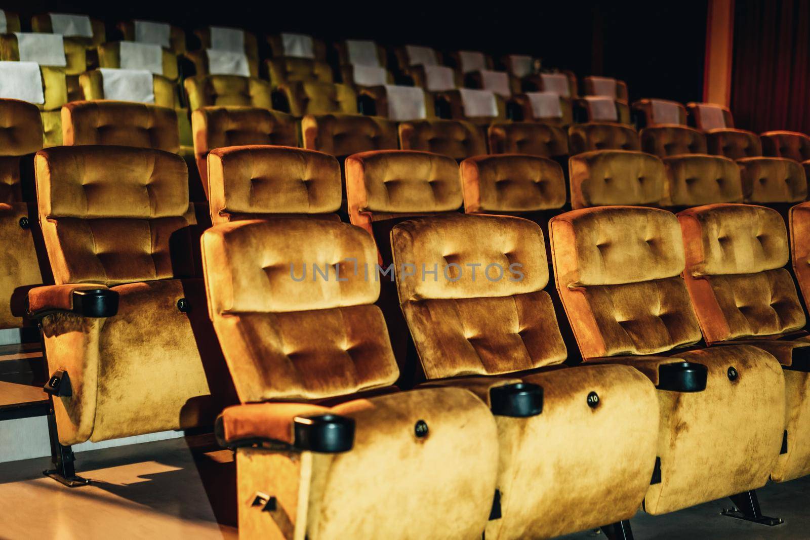 A row of yellow seat with popcorn on chair in the movie theater