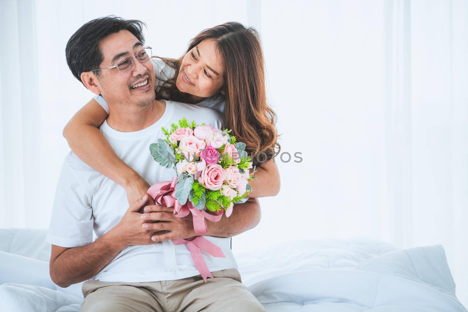 Happy Asian senior couple having good time at home. Old people retirement and healthy citizens elderly concept.