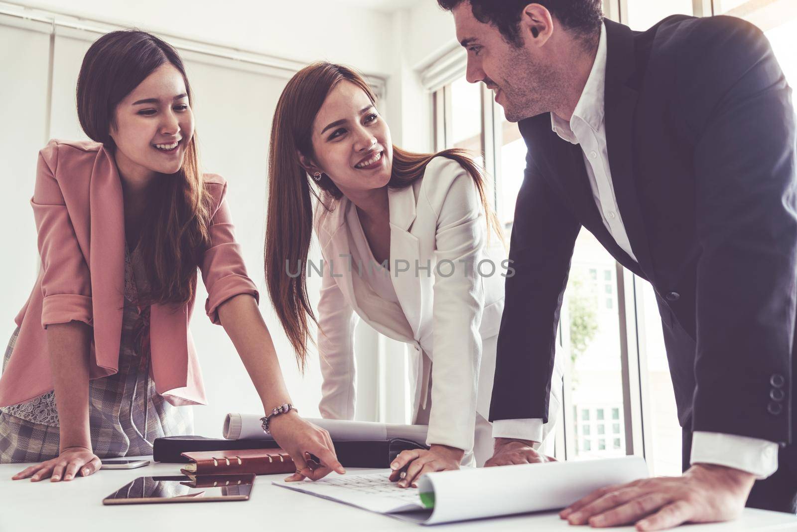 Businessman is in meeting discussion with colleague businesswomen in modern workplace office. People corporate business team concept.