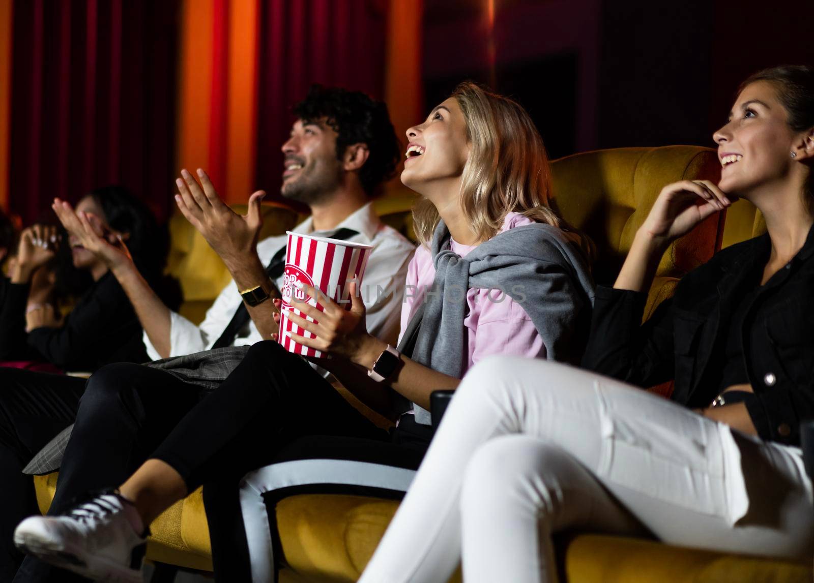 People audience watching movie in the movie theater cinema. Group recreation activity and entertainment concept.