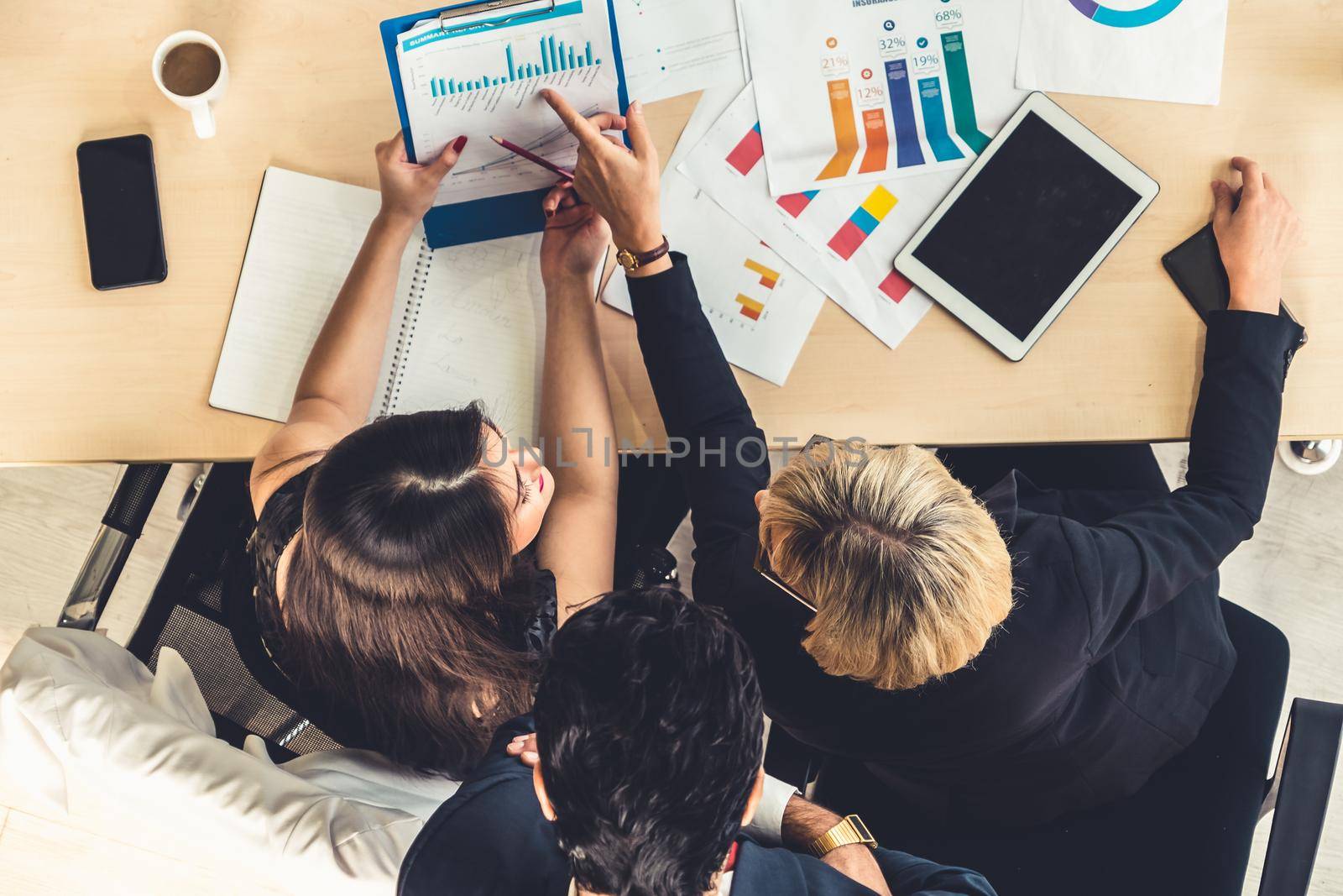 Business people group meeting shot from top view in office . Profession businesswomen, businessmen and office workers working in team conference with project planning document on meeting table .