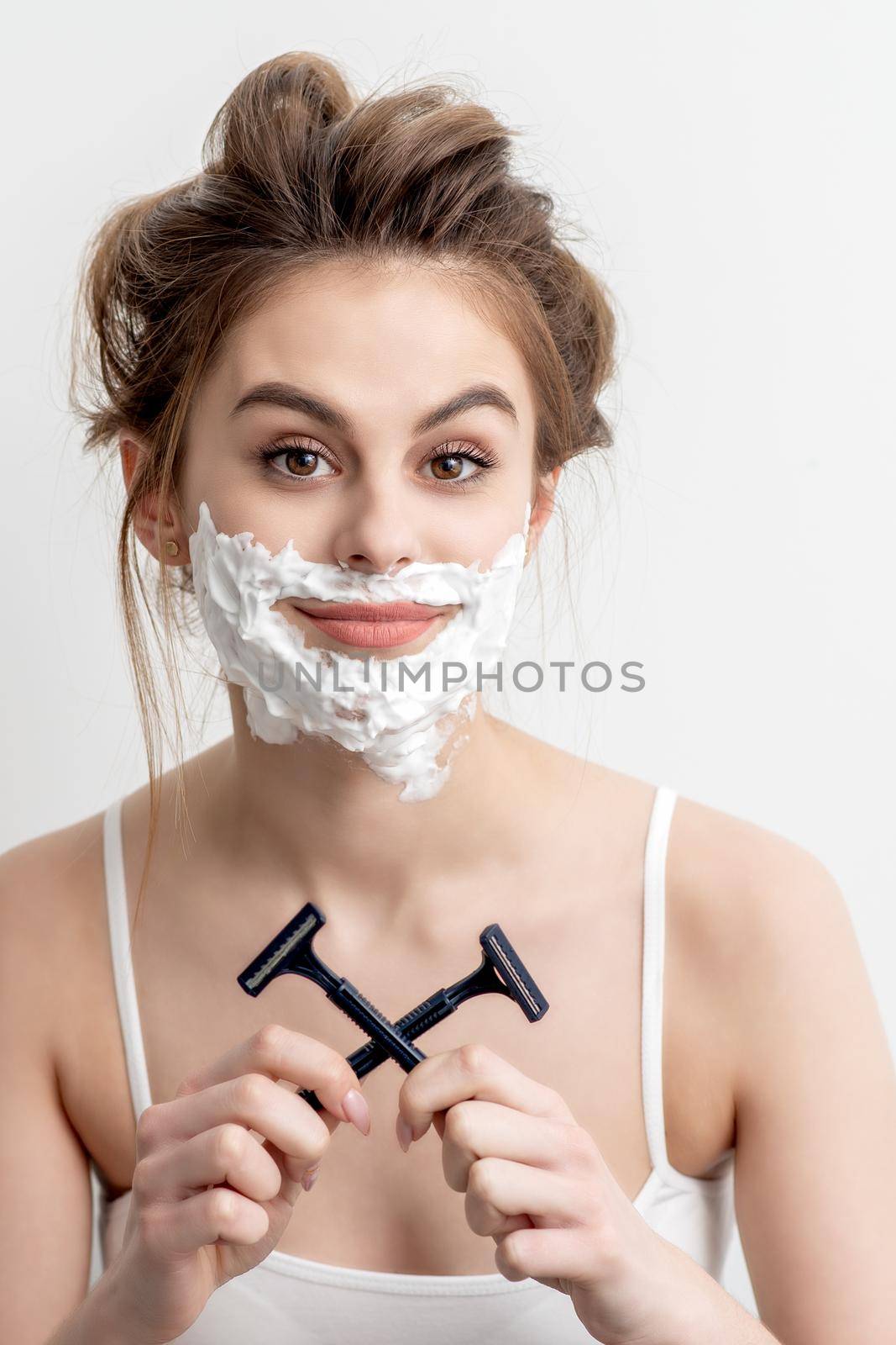 Woman with shaving foam on her face by okskukuruza