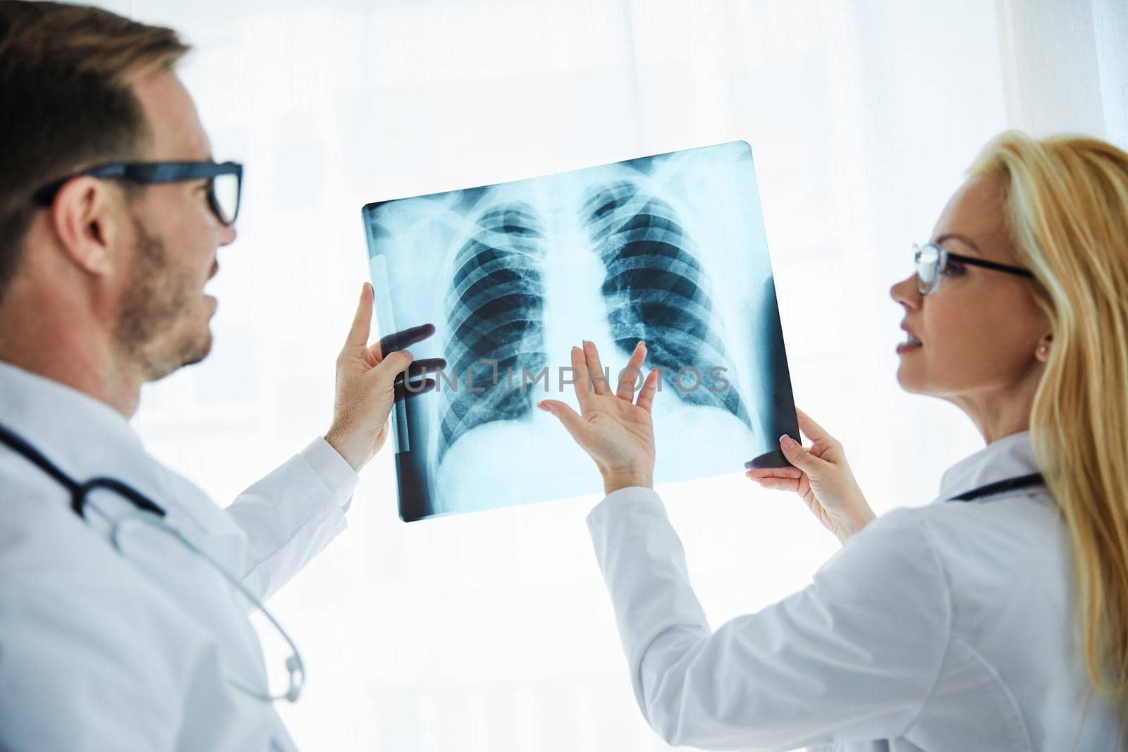 Doctors looking at a x-ray image in their hospital office