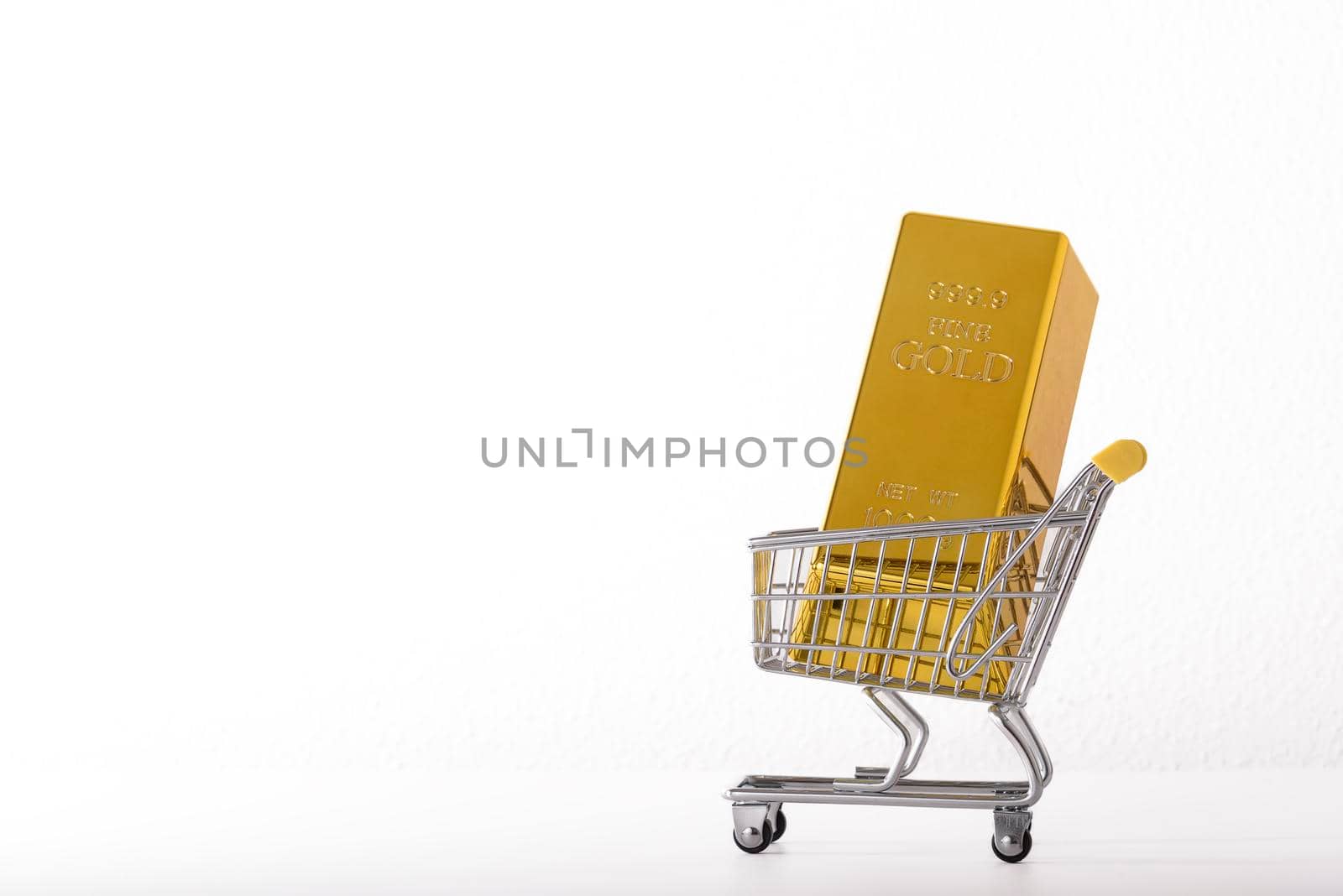 Toy supermarket cart or shopping trolley with money isolated on white background close-up