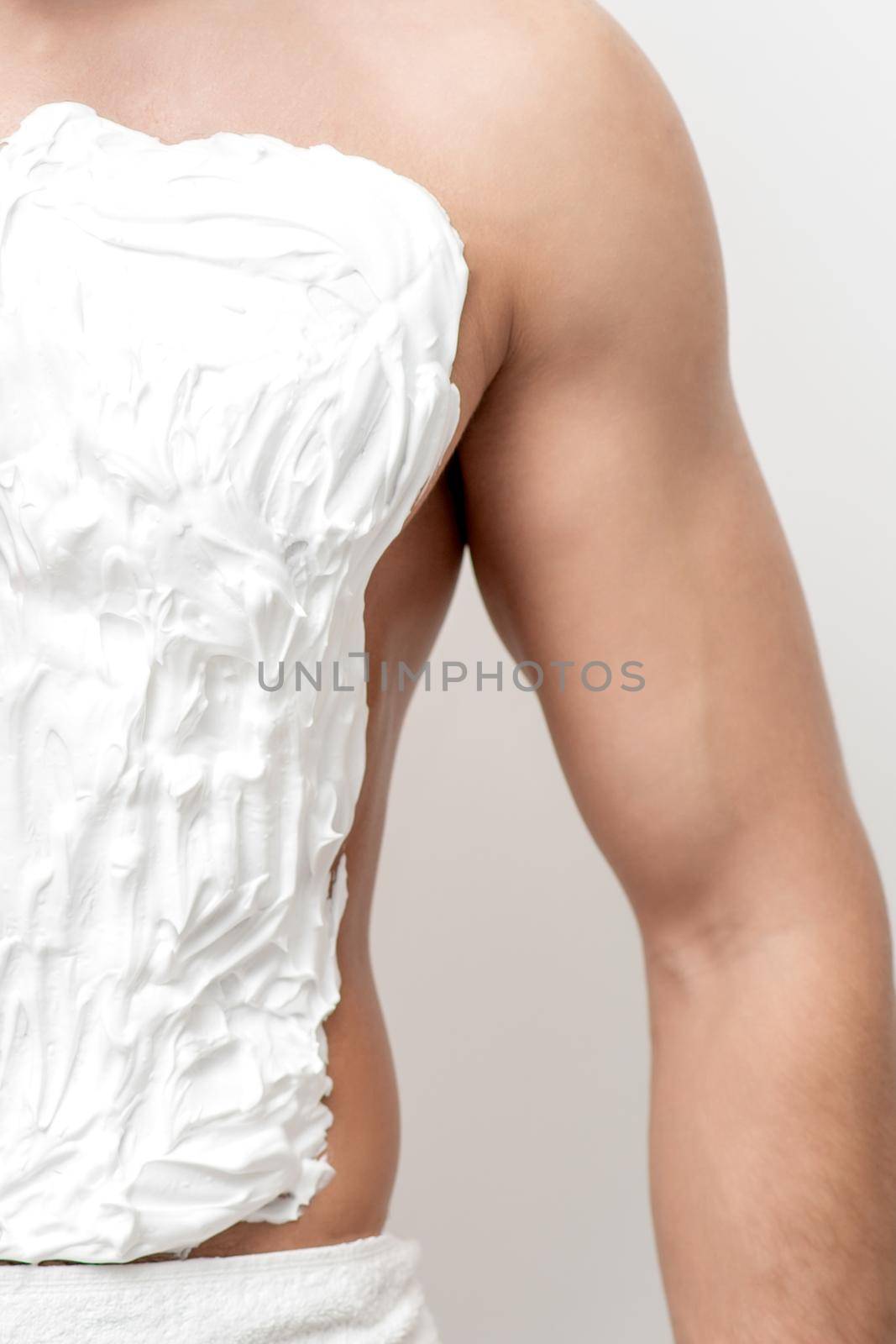 Close up of chest with shaving foam of young white caucasian man