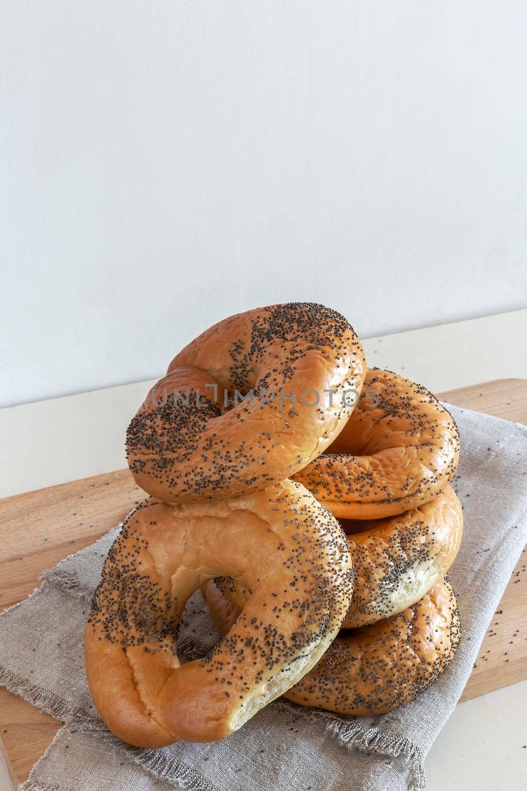 Bagels with poppy seeds on a napkin by georgina198