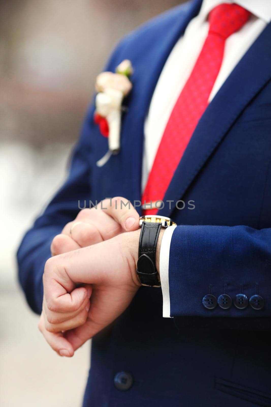 Preparing for wedding. Groom buttoning cufflinks on white shirt before wedding. True men's accessory. Groom's clothes.