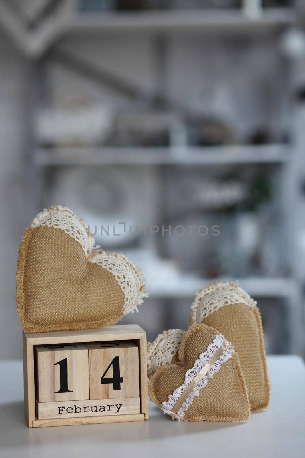 Valentines day concept. heart beside wooden block calendar set on Valentines date 14 February on table and bright room background.