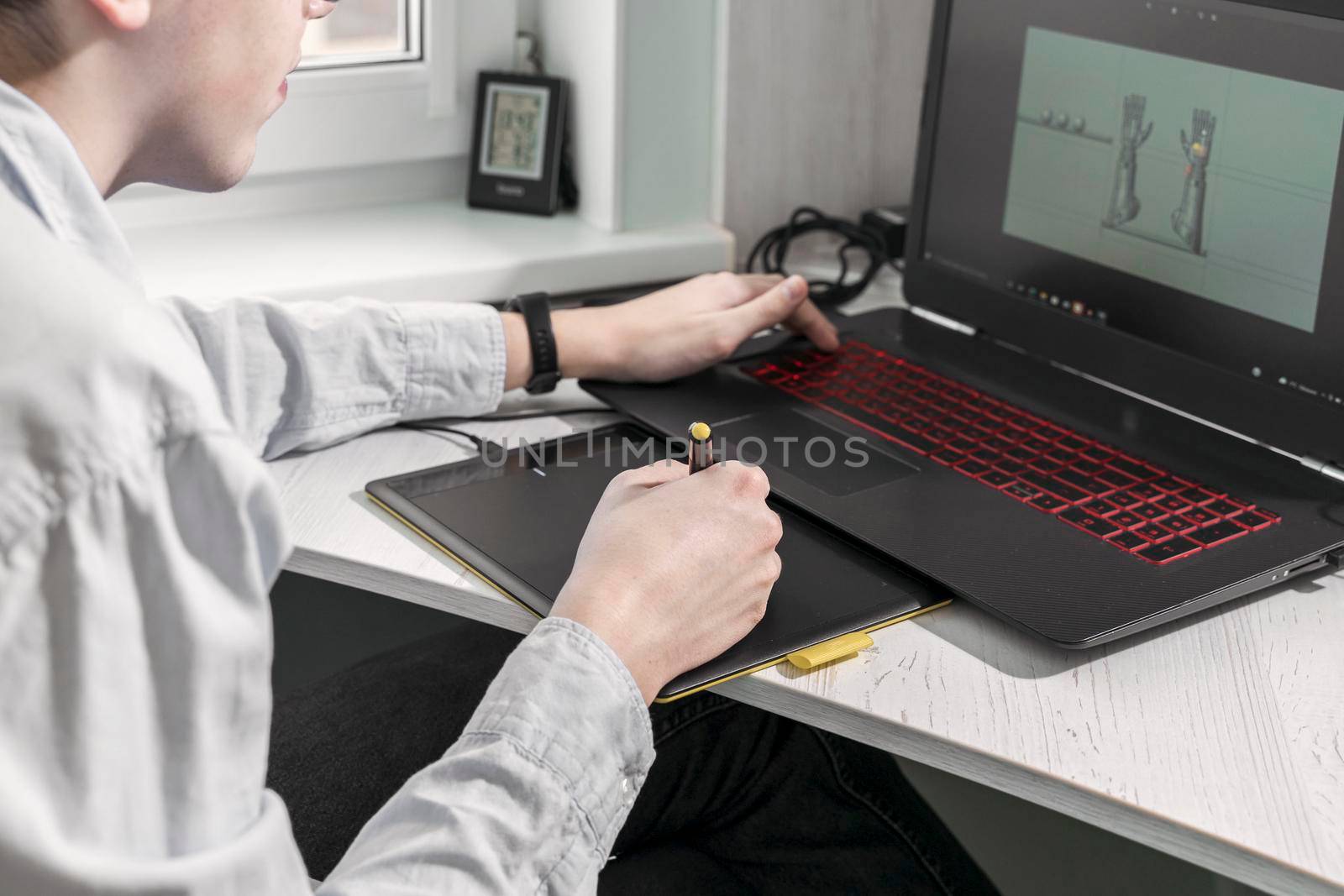 digital artist man working on 3d graphics using a graphics tablet by Lena_Ogurtsova