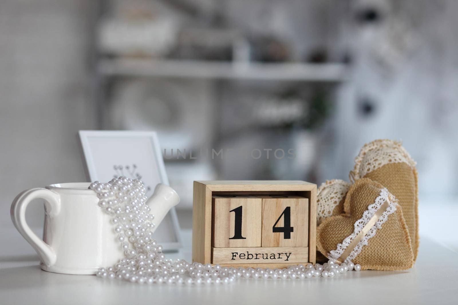Valentines day concept. heart beside wooden block calendar set on Valentines date 14 February on table and bright room background.