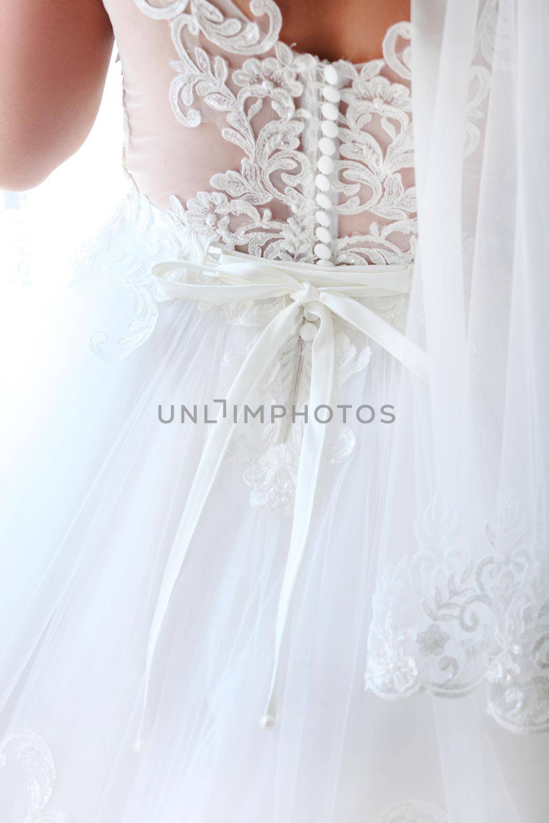 Bride dressing wedding gown