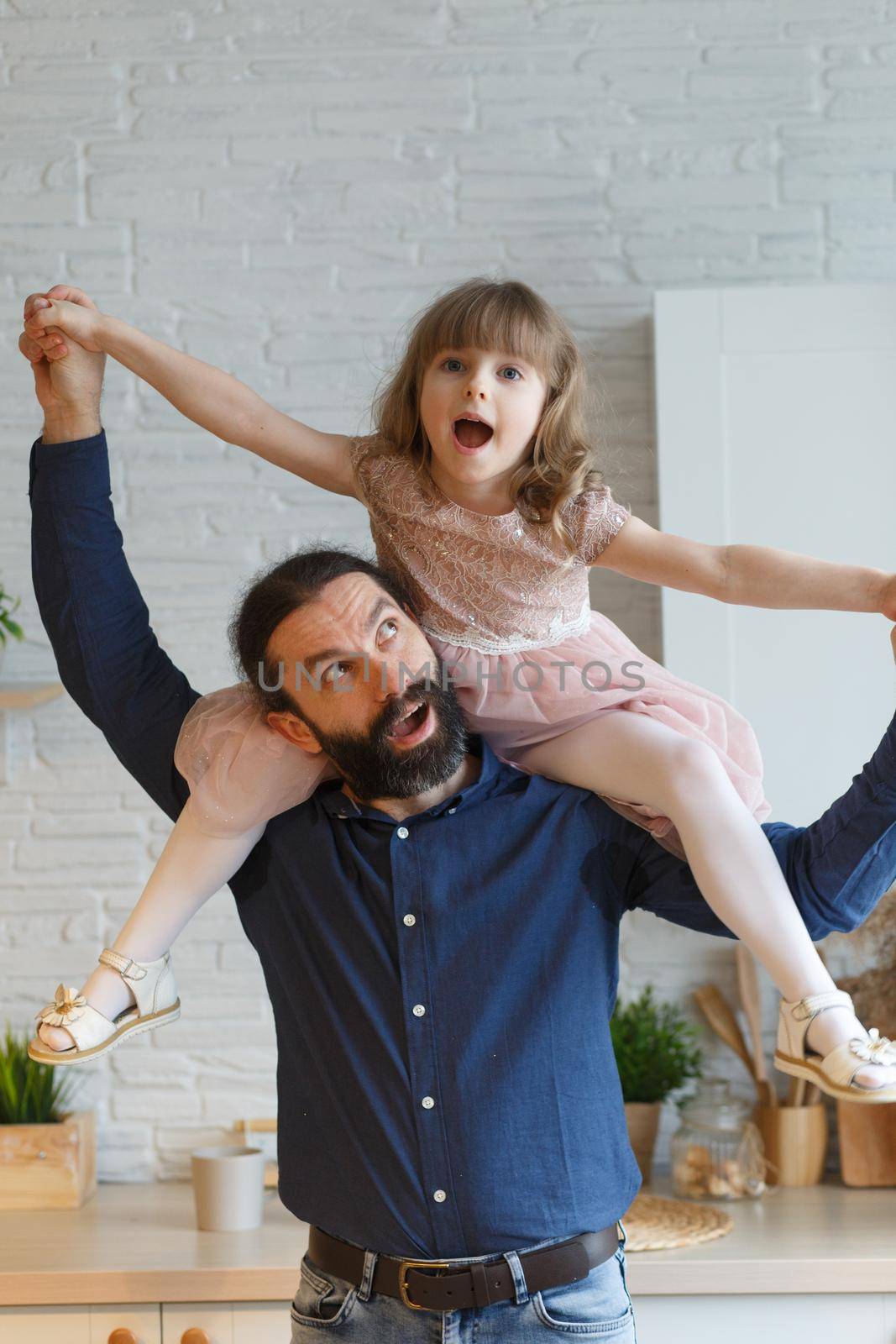 Happy little daughter sitting on father neck by BY-_-BY