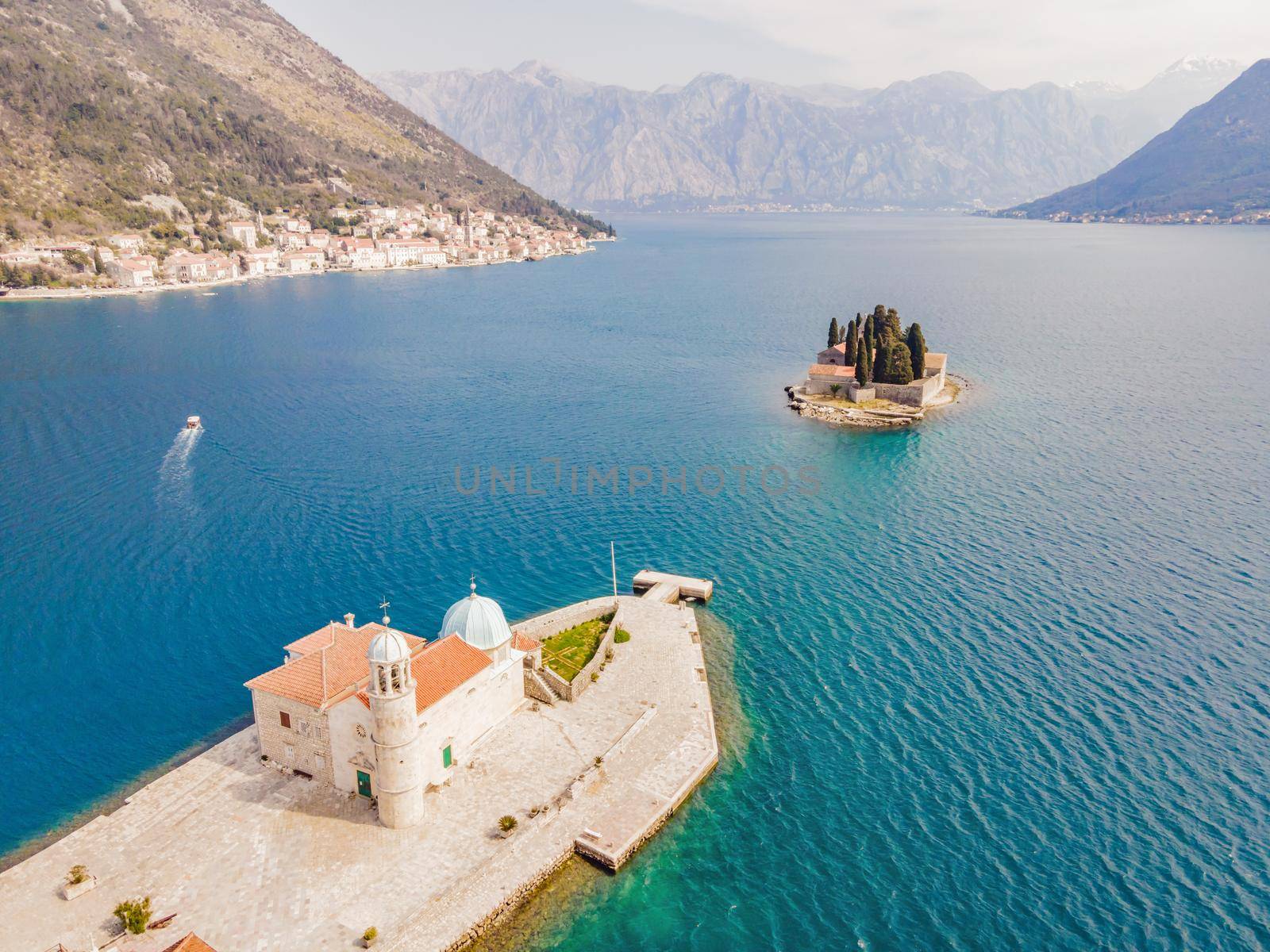 Picturesque island st. George and temple Gospa od Skrpela. Drone view. Boka Kotor Bay, Perast, Montenegro. Ancient Church Crkva Gospa od Skrpjela. Amazing mountain landscape. Beautiful gulf Kotor. Adriatic coast.