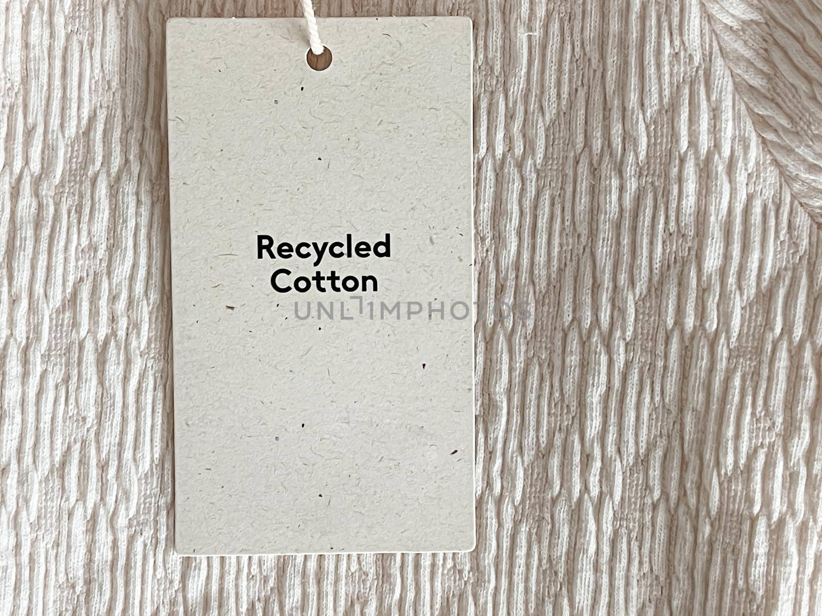 Recycled cotton fashion label tag, sale price card on luxury fabric background, shopping and retail by Anneleven