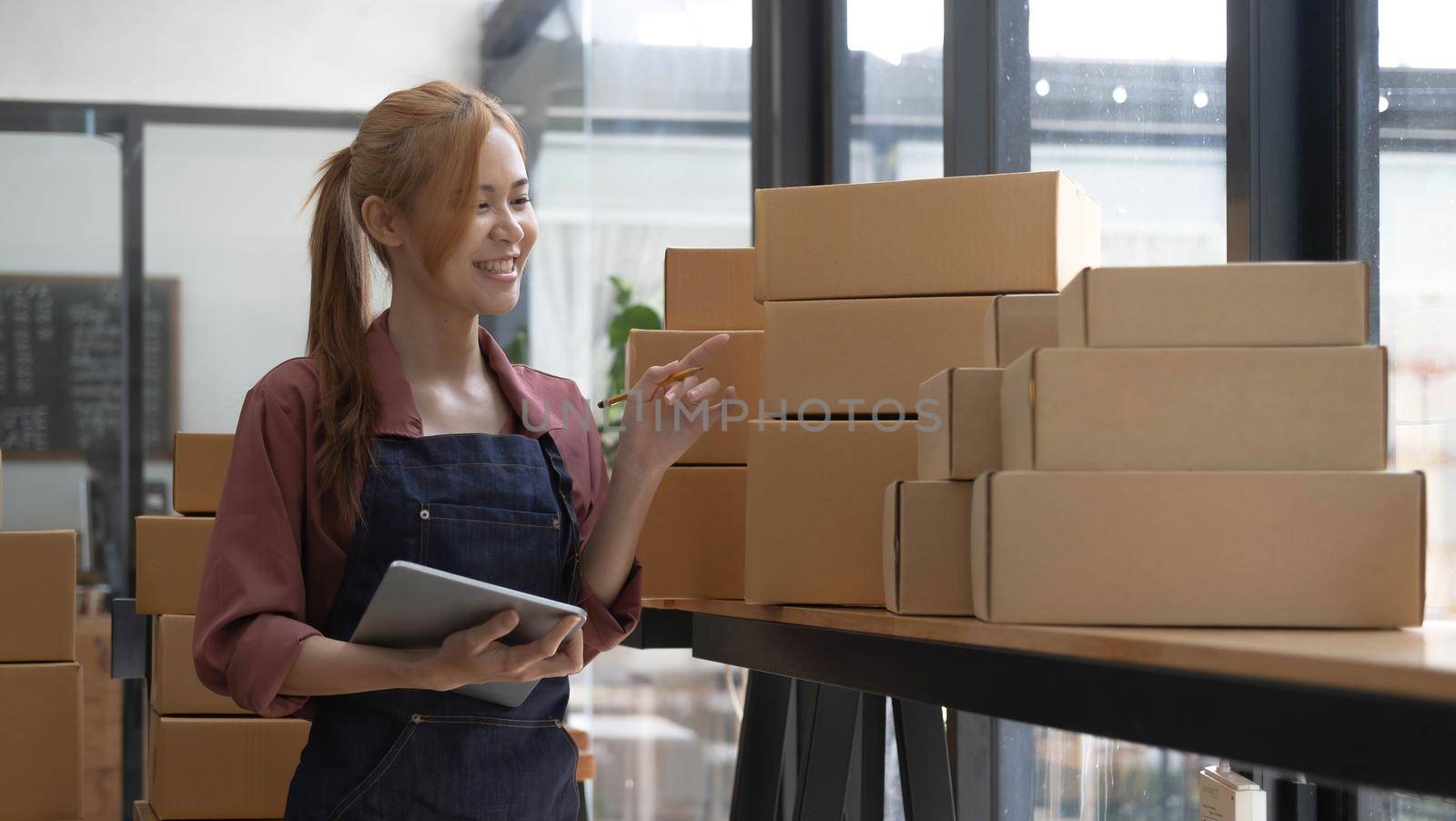 Portrait of Starting small businesses owners female entrepreneurs working on receipt box and check online orders to prepare to pack the boxes, sell to customers, sme business ideas online..
