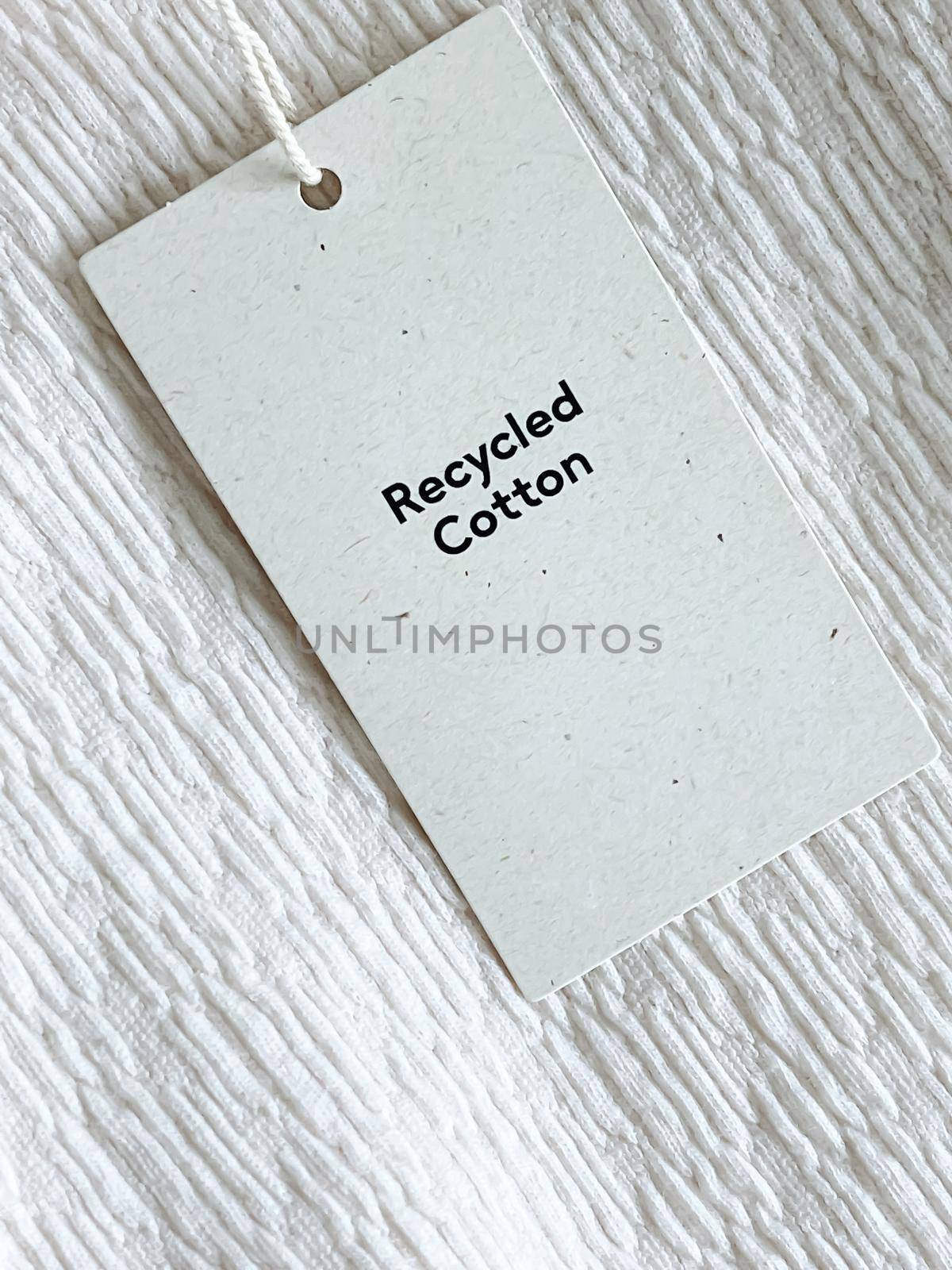 Recycled cotton fashion label tag, sale price card on luxury fabric background, shopping and retail concept