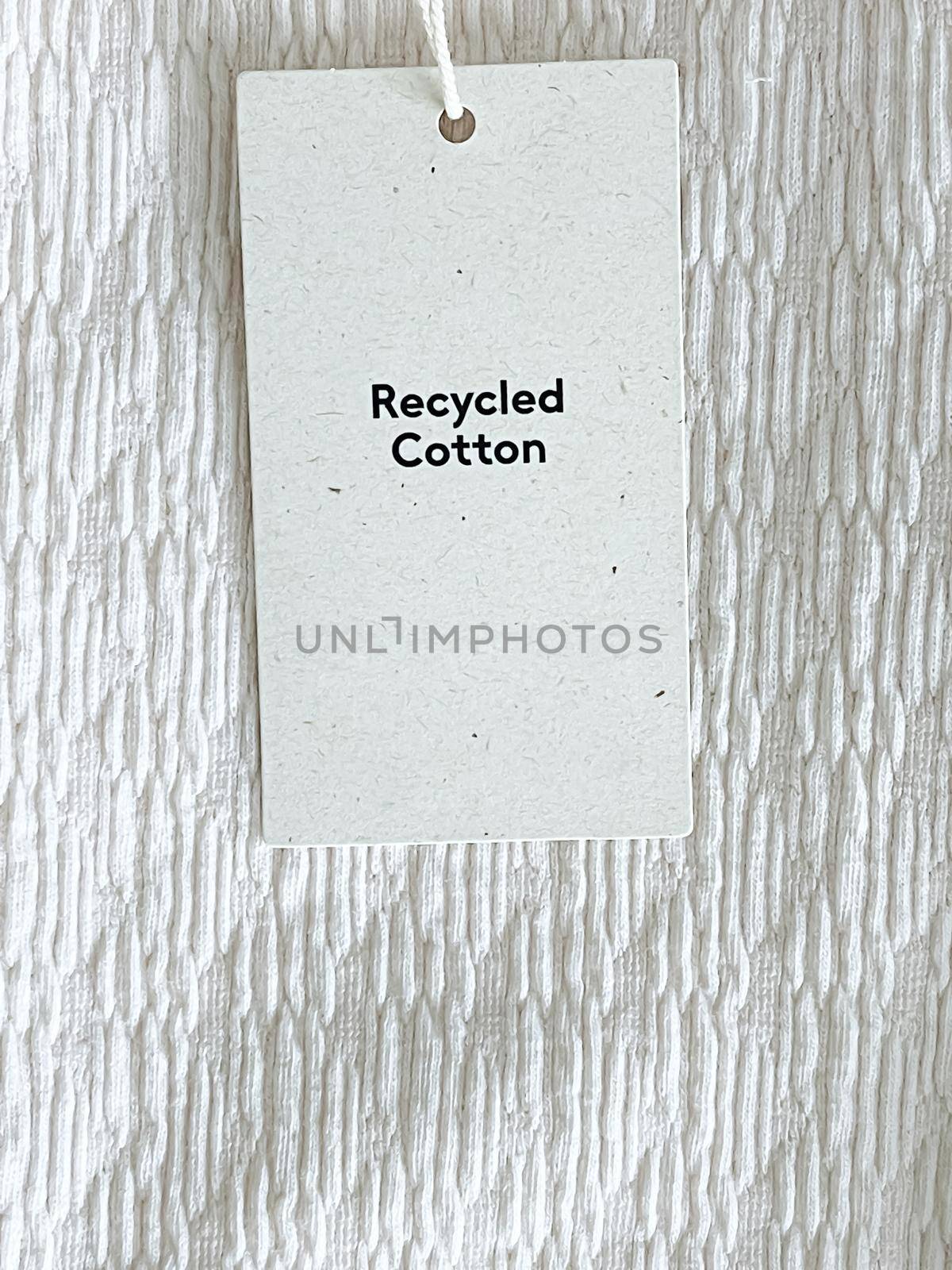 Recycled cotton fashion label tag, sale price card on luxury fabric background, shopping and retail concept