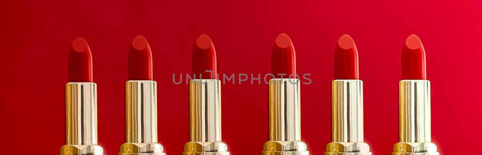Red lipstick in golden tubes on colour background, luxury make-up and cosmetics for beauty brand product design concept